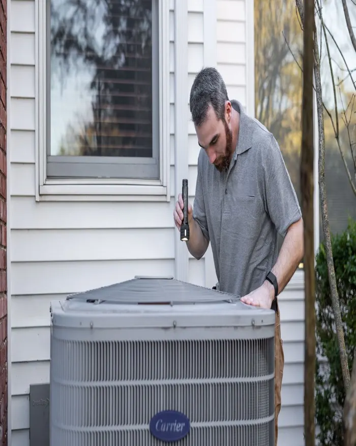 HVAC technician servicing a unit